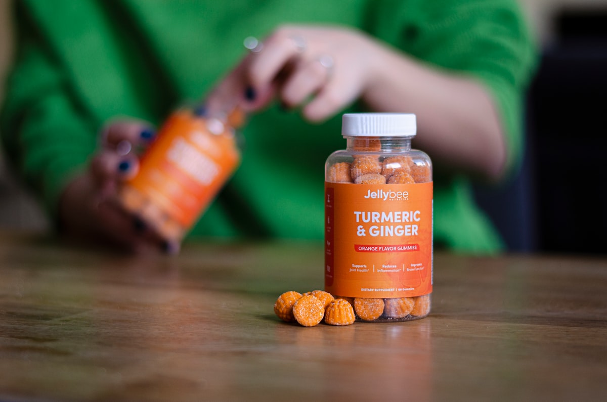 Close-up of turmeric roots, collagen powder, and botanical extracts